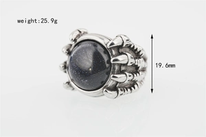 Macro shot of punk style dragon claw ring featuring blue goldstone and weight specs
