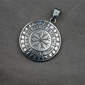 Vintage Viking compass pendant in stainless steel with Nordic runes on grey background