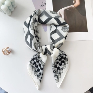 Detail of elegant black and white silk scarf with floral checkers and pearl motifs