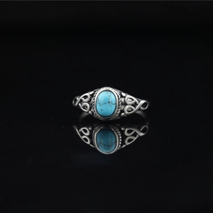 Vintage oxidized titanium steel ring featuring an oval turquoise stone and filigree