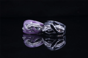 Detailed close-up of intertwined wave rings with purple and black oil drip finish