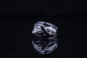 Close-up of interlocking silver titanium ring band with pavé set clear gemstones