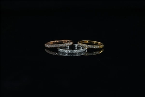 Close-up of eternity bands in rose gold, silver, and gold with sparkling crystals