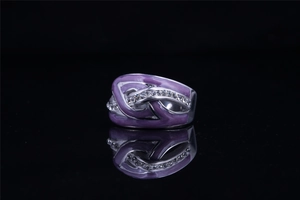 Detail of silver twisted titanium steel ring with purple enamel and white zircon stones