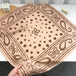 Close-up of soft paisley clover square scarf with premium silk-like texture and details
