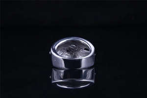 Macro view of wide stainless steel ring showing hollow base structure and inner texture