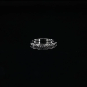Elegant silver stainless steel eternity ring with cubic zirconia on a black mirror background