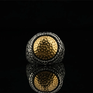 Retro two-tone stainless steel ring featuring gold textured center and braided silver rope