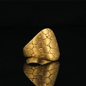 Punk style textured nugget ring in matte gold finish with irregular patterns and reflections
