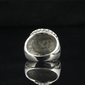 Vintage oxidized titanium steel ring with intricate filigree patterns and mirror reflection