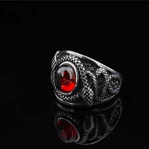 Bague vintage en acier titane avec pierre rouge et texture détaillée d'écailles de dragon