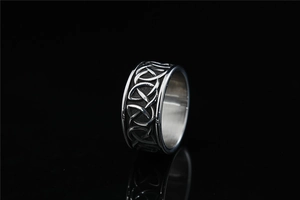 Detailed view of Viking Celtic knot engravings on a dark silver stainless steel ring
