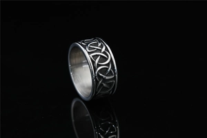 Detail of vintage Celtic knot pattern on wide silver stainless steel punk ring