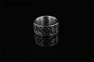 Macro shot of vintage Viking Celtic knot patterns on a silver stainless steel punk ring