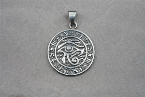 Macro shot of stainless steel Eye of Horus pendant with ancient Egyptian hieroglyphics