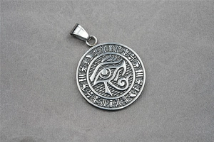 Detail of Eye of Horus relief on round titanium steel pendant with Egyptian symbols