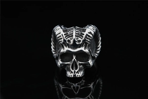 Macro shot of punk skull ring with ram horns featuring vintage oxidized steel texture