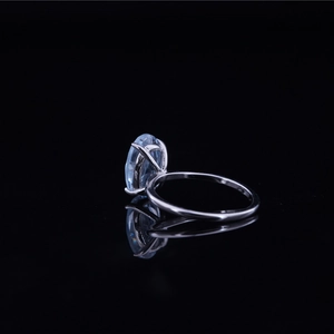 Minimalist titanium steel ring featuring an oval-cut light blue gemstone on black mirror