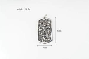 Detail view of military tag pendant with embossed crucifix and grainy texture finish