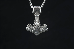 Macro shot of Viking hammer pendant with intricate Valknut symbol and Norse engravings