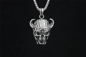 Macro detail of viking skull pendant with ox horns in antique silver stainless steel