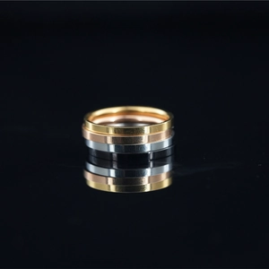 Stack of four minimalist stainless steel rings in gold silver rose gold and black colors