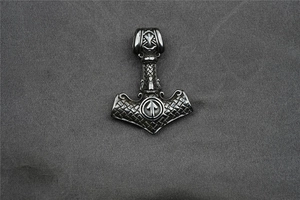 Detailed view of Viking Mjölnir pendant with Celtic patterns and Tiwaz rune engraving