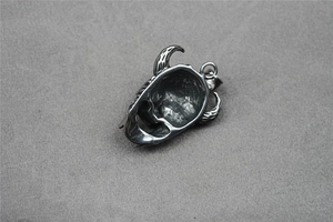 Macro view showing the detailed hollow back of the gothic bull horn skull steel pendant
