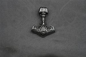 Detailed close-up of a Viking Mjolnir pendant with intricate Celtic knotwork patterns