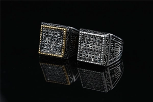 Macro detail of retro punk square rings with black stones and crown carvings