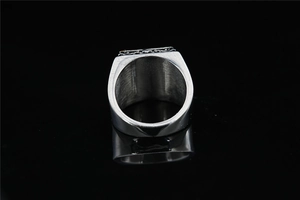 Detailed view of heavy silver stainless steel signet ring with vintage embossed top