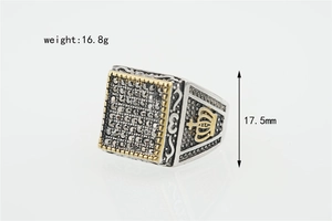 Detail shot of vintage silver square signet ring with black zircon and gold crown relief