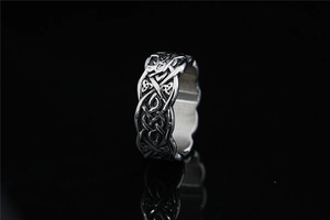 Detailed view of silver Celtic Knot ring with intricate Nordic woven textures on black mirror