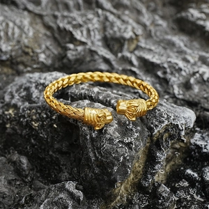 Vintage gold tiger head braided titanium steel open cuff bracelet on dark rock background