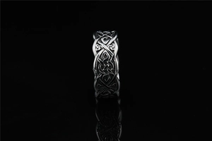 Macro shot of Viking Celtic knot pattern with black oxidation on wide band ring
