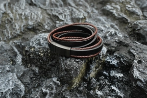 Macro detail of multilayer leather cord bracelet with vintage steel magnetic clasp