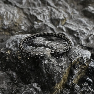 Vintage braided titanium steel open cuff bracelet with dual tiger heads on black rock
