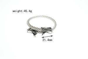 Detail shot of vintage stainless steel twisted cable bracelet with carved dragon heads