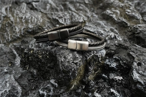 Detail view of men's braided leather bracelets with brushed magnetic steel clasps