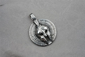 Macro shot of 3D Spartan helmet and shield pendant with Greek key patterns