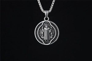Detail of vintage Saint Benedict medal necklace with oxidized titanium steel finish