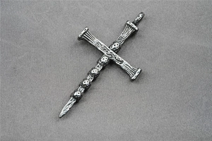 Detailed macro view of vintage gothic cross pendant with miniature skull ornaments