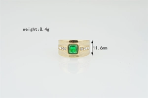 Detailed macro view of gold-plated ring with emerald gemstone and side diamond accents