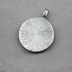 Warrior mask medallion steel necklace with radial texture and V-pattern bail