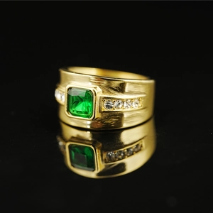 Golden emerald-cut green gemstone ring with side diamonds and hammered steel texture