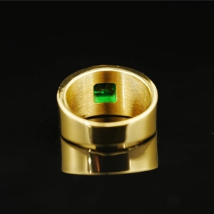 Men's wide gold titanium ring featuring a square emerald gemstone and polished finish