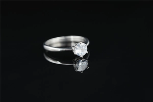 Macro shot of a classic six-prong titanium steel ring with a round brilliant moissanite stone