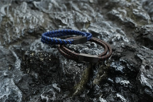 Detailed shot of double-layered braided rope bracelets with matte black magnetic buckles