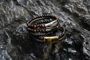 Detail of multi-layer braided leather bracelets with tiger eye stones and magnetic clasps
