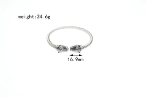Detailed view of leopard head bangle with green stone eyes and 24.6g weight marker